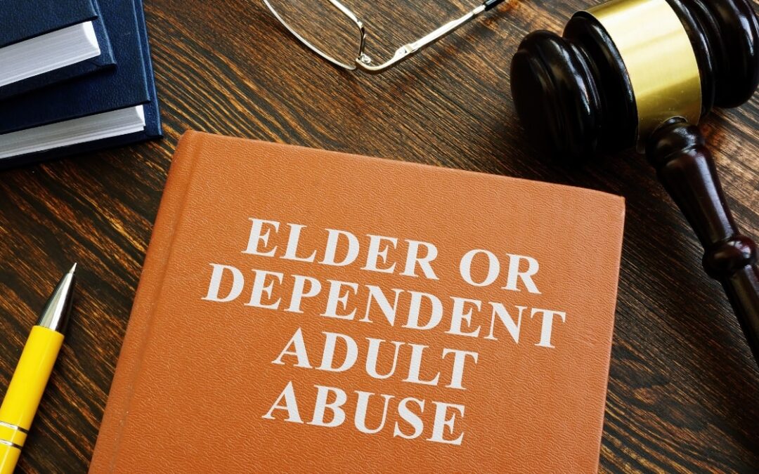 Book on a lawyers desk that has elder or dependent adult abuse on the cover