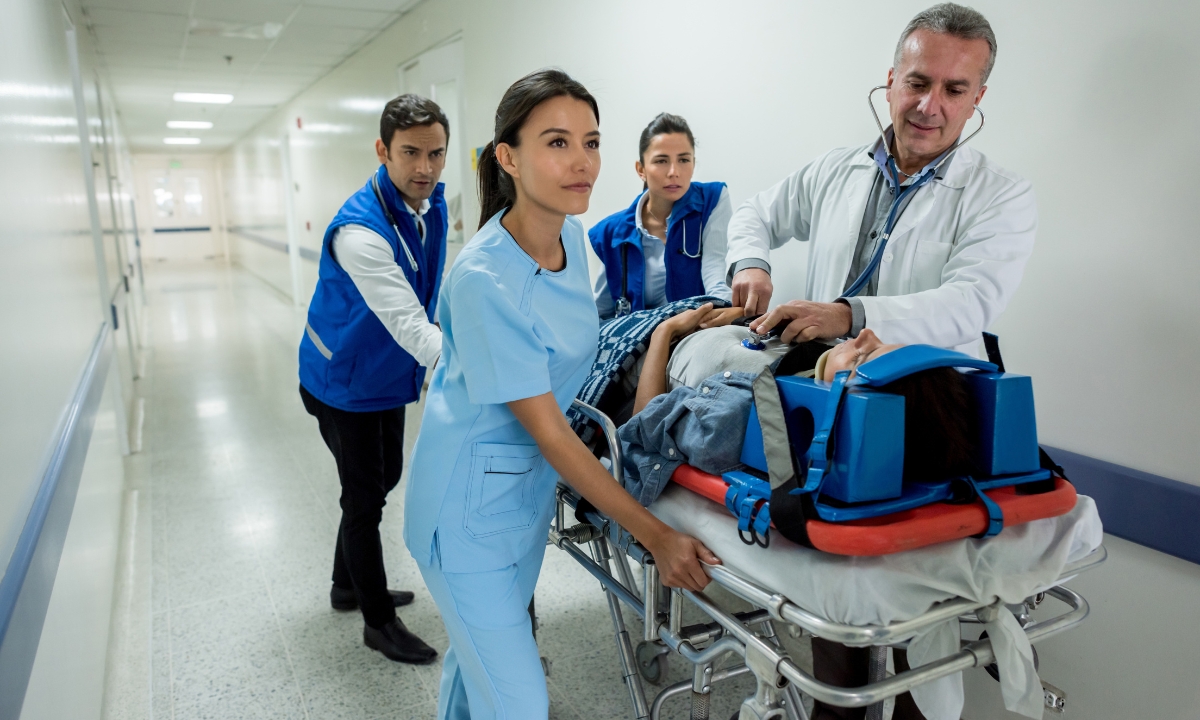 doctors ad nurses wheeling a bed through a hospital